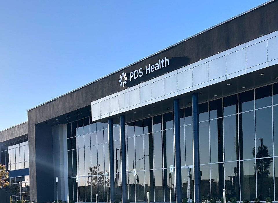 PDS Health employee reviewing latest company news online