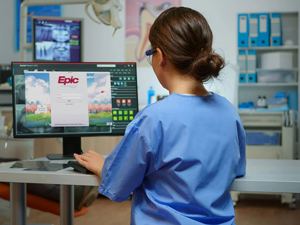 Epic screen being operated by a female practitioner
